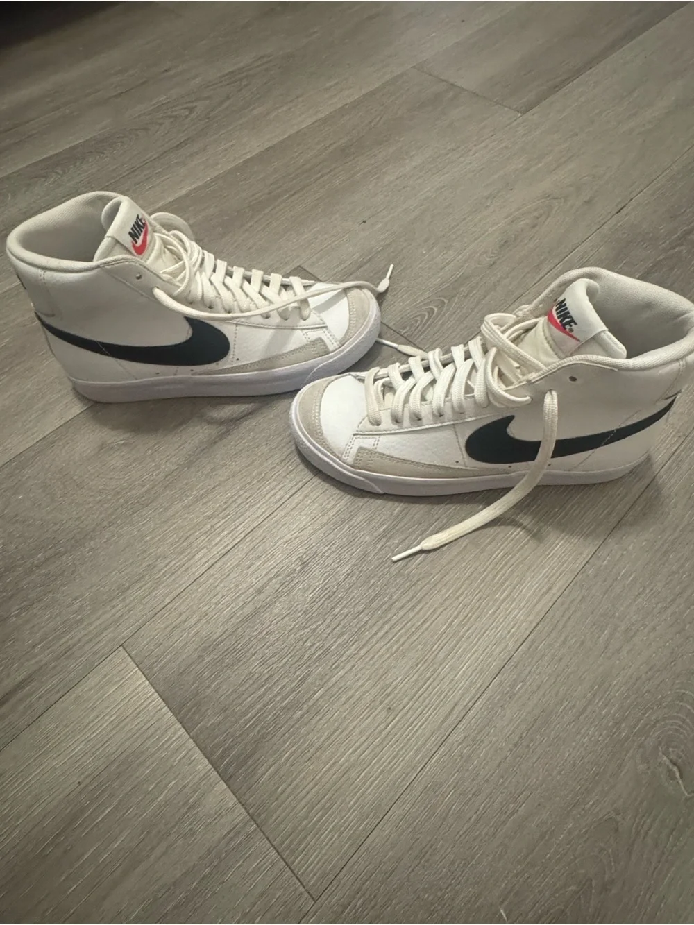 Nike Women's White High-Top Sneakers with Black Swoosh